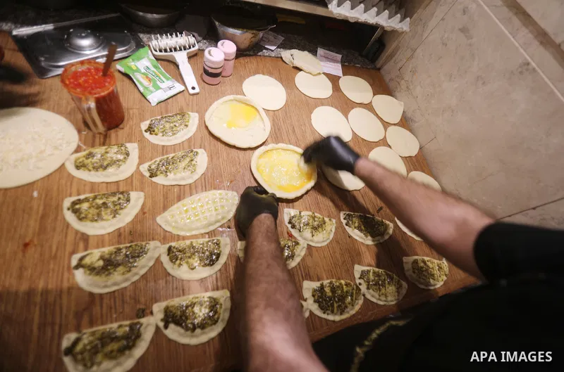 Palestinian workers prepar pastries to sell to customers in a bakery, in Gaza city, on December 2021. According to a report issued by the Palestinian Central Bureau of Statistics, the unemployment rate in the Gaza Strip...