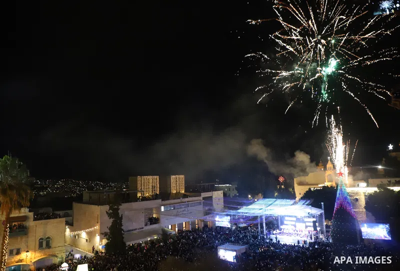 Palestinians light Christmas tree in Manger Square outside the Church of the Nativity in the West Bank city of Bethlehem on December 4, 2021. Christmas is an annual festival commemorating the birth of Jesus Christ, obser...
