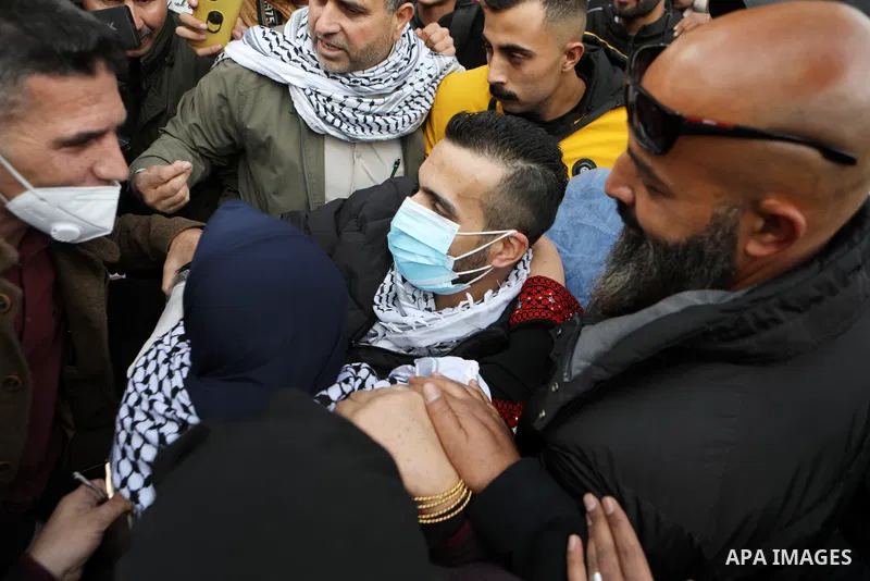 Palestinian prisoner Kayed al-Fasfous greets people after Israeli authorities released him following after he concluded 131 days of hunger strike, in the West Bank city of Hebron, on December 5, 2021. On November 23, Fas...