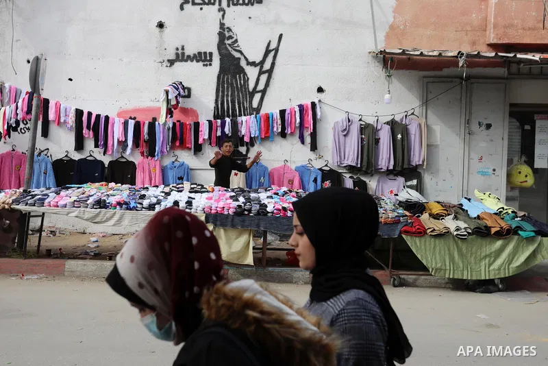 Palestinians walk at a local market in Gaza city on December 06, 2021. Photo by Ashraf Amra