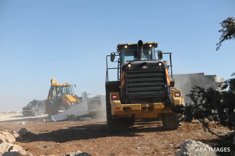 An Israeli bulldozer demolished a Palestinian house located under the pretext of building without a permit in Yatta south of Hebron in the West Bank, on December 06, 2021. According to a report by the Israeli human right...
