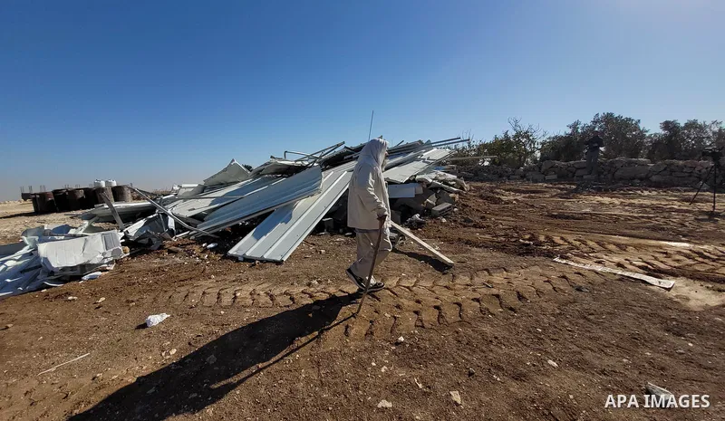 An Israeli bulldozer demolished a Palestinian house located under the pretext of building without a permit in Yatta south of Hebron in the West Bank, on December 06, 2021. According to a report by the Israeli human right...