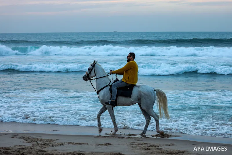 Palestinians enjoy their time on the beach, in Gaza City, On December 6, 2021. The beach is one of the few open public spaces in this densely populated city. Photo by Atia Darwish
