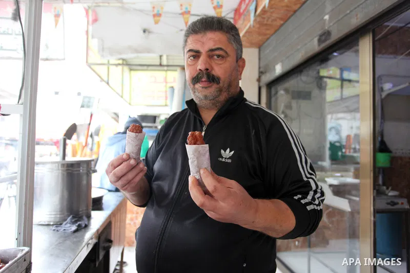 Palestinian vendor prepares traditional sweet called "awwamah" during winter, at Al Shati refugee camp, in Gaza city on December 9, 2021. Awwamah is a traditional sweet, Gazans eat it on winter. Weather today is partly c...