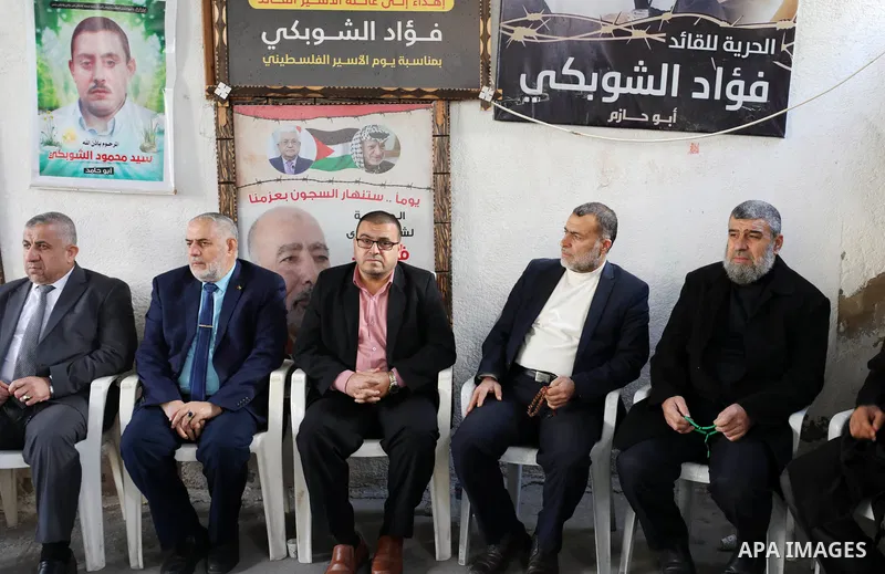 Members of Hamas movement visit families of Palestinian prisoners and wounded, marking the 34th anniversary of the founding of the Hamas movement, in Gaza city on December 9, 2021. Photo by Mahmoud Nasser