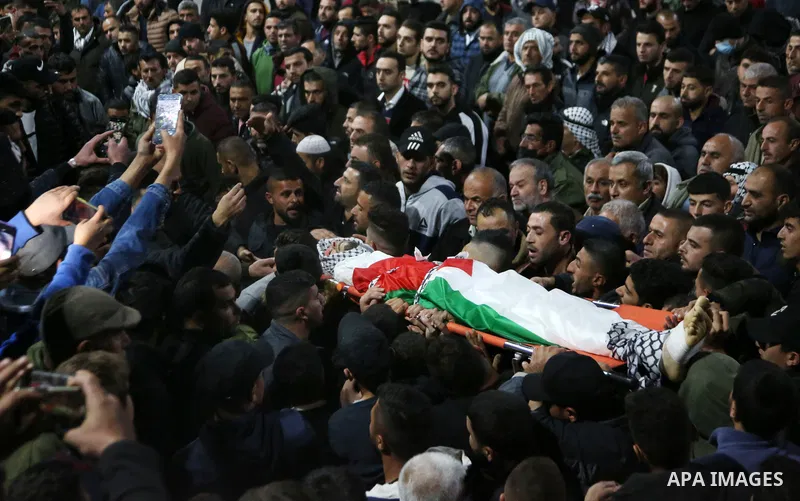 Palestinians carry the body of a Jamil Abu Ayyash, 31, who was shot killed by Israeli forces during his funeral in the West Bank city of Nablus, on December 10, 2021. Abu Ayyash suffered a gunshot wound to the head durin...