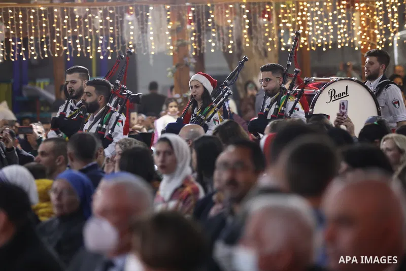 Palestinians gather to celebrate the lighting of the Christmas tree in Gaza city on December 10, 2021. Photo by Ashraf Amra