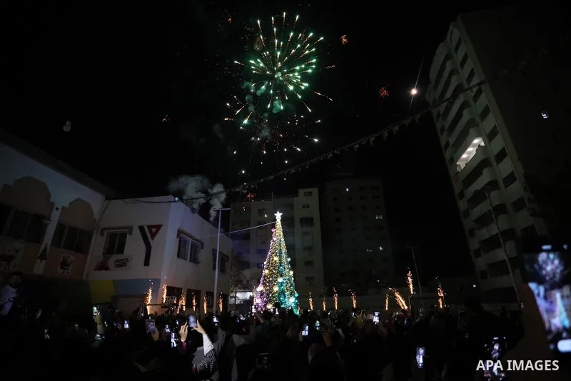 Palestinians gather to celebrate the lighting of the Christmas tree in Gaza city on December 10, 2021. Photo by Ashraf Amra