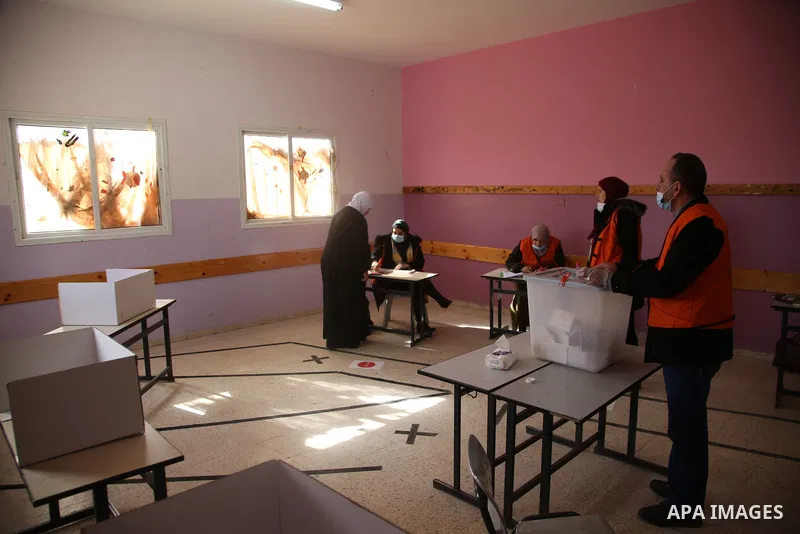 Palestinian voters cast their vote in the first phase of local elections in village of Hawara in the northern West Bank, on December 12, 2021. Polls opened this morning for the first phase of local elections at 154 Pales...