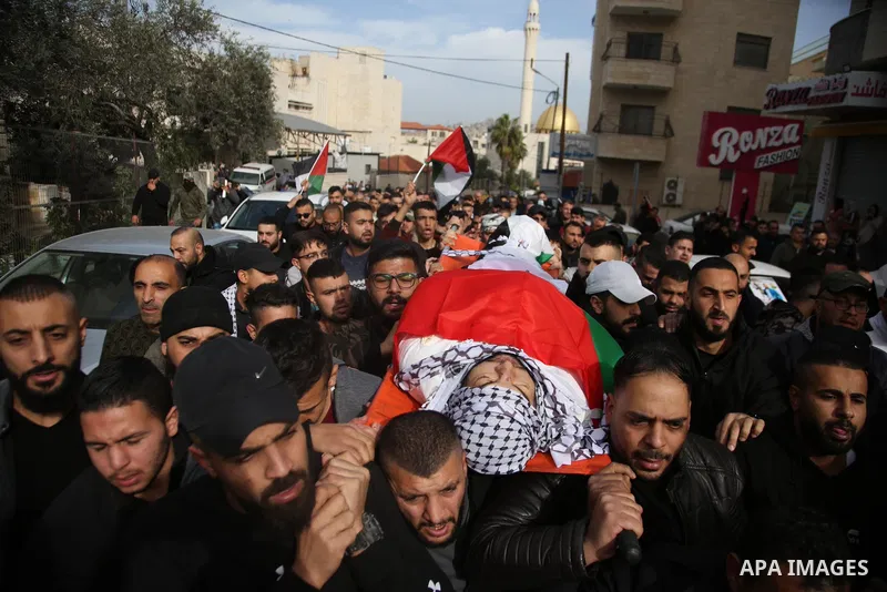 Palestinians carry the body of Jameel al-Kayyal, who was killed by Israeli soldiers, during his funeral in the West Bank city of Nablus on December 13, 2021. Israeli forces Monday killed a Palestinian youth and injured t...