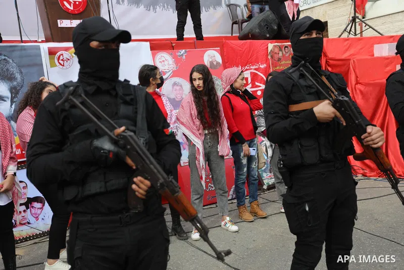 Palestinian supporters of the Popular Front for the Liberation of Palestine (PFLP) take part during a rally marking the 54th anniversary of its founding in Gaza City on December 13, 2021. Photo by Ashraf Amra