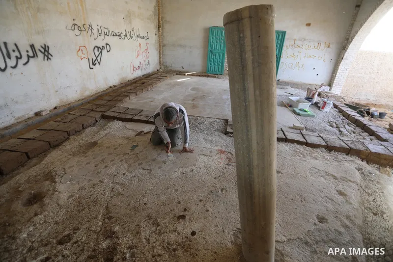 Volunteers and archaeologists restore the floor of the Byzantine church mosaic, in Khan Younis in the southern Gaza Strip, on December 20, 2021. The Iwan Center for Cultural Heritage at the Islamic University, in coopera...