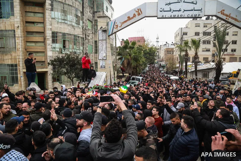Mourners carry the body of Palestinian Mohammed Issa Abbas, who reportedly fired on Israeli troops in the West Bank and was shot dead by Israeli forces returning fire, during his funeral at the al-Amari refugee camp in R...