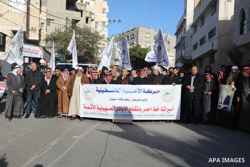 Palestinians hold placards during a protest in solidarity with female prisoners at Israeli jails, in Deir Al Balah in the center of Gaza strip on December 21, 2021. Photo by Ashraf Amra