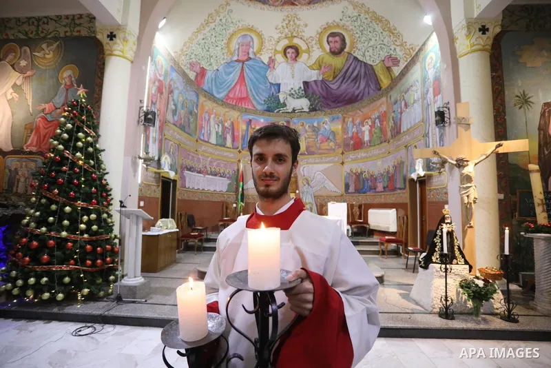 Palestinian Christians attend Christmas mass eve at the Roman Catholic Church of the Holy Family in Gaza City on December 24, 2021. Photo by Ashraf Amra
