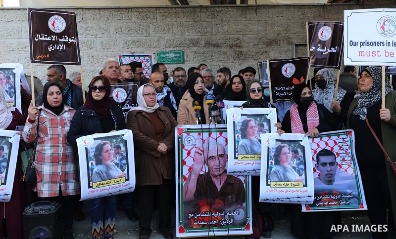 Palestinians take part in a protest to show solidarity with female prisoners held in Israeli jails, ​in front of Red Cross office in Gaza city, on December 27, 2021. Palestinian administrative detainees usually resort to...