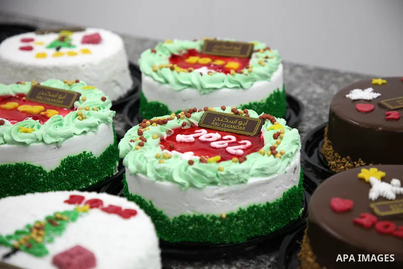 Palestinian chefs put final touches on cakes which portrays the new year number "2022", in Gaza city 30, 2021. Gazans hope for peace, prosperity in 2022 after the recent 11-day conflict between Israel and Hamas on May. P...