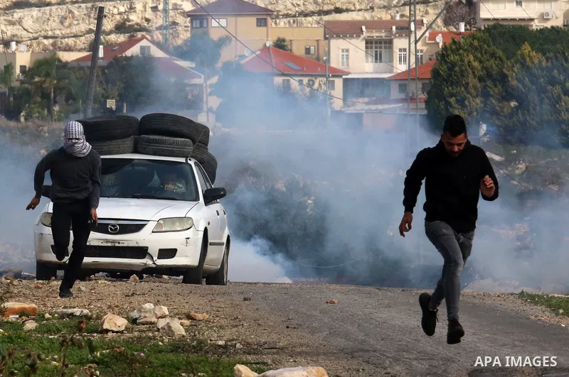 Palestinian protesters clash with Israeli security forces following a demonstration against the expropriation of land by Israel, in the village of Kfar Qaddum near the Jewish settlement of Kedumim in the West Bank on Dec...