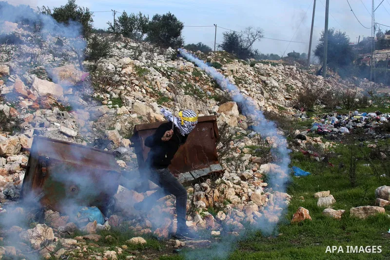 Palestinian protesters clash with Israeli security forces following a demonstration against the expropriation of land by Israel, in the village of Kfar Qaddum near the Jewish settlement of Kedumim in the West Bank on Dec...