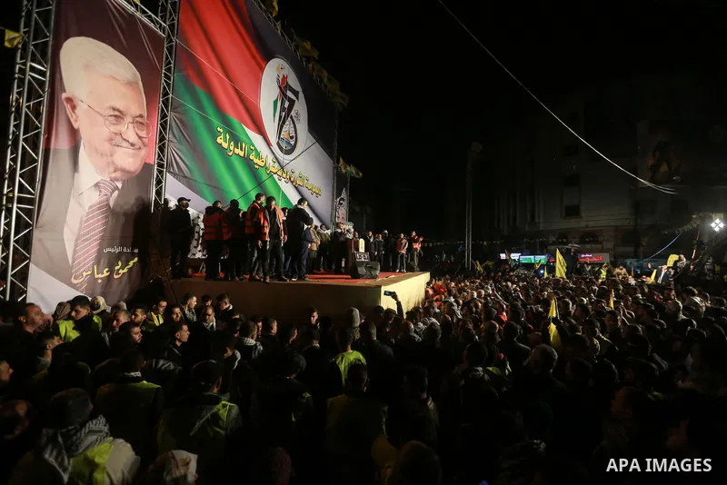 Palestinians light a torch during a celebration marking the 57th anniversary of Fatah movement foundation, in Gaza city on Decemeber 31, 2021. Photo by Mohammed Dahman
