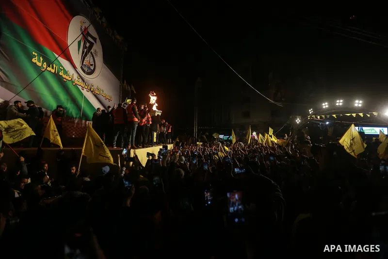 Palestinians light a torch during a celebration marking the 57th anniversary of Fatah movement foundation, in Gaza city on Decemeber 31, 2021. Photo by Mohammed Dahman
