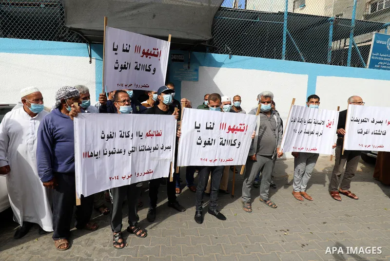 Palestinian owners of houses which were destroyed during the Israeli war of 2014, take part in a rally demanding for reconstruction of their houses, outside the United Nations Relief and Works Agency (UNRWA), in Khan Yun...