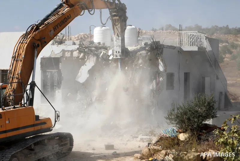 An Israeli bulldozer demolishes a Palestinian home in Jawaya village near Yatta in area "C", of the southern part of the West Bank town of Hebron, on October 3, 2021, which according to Israel was built without authorisa...