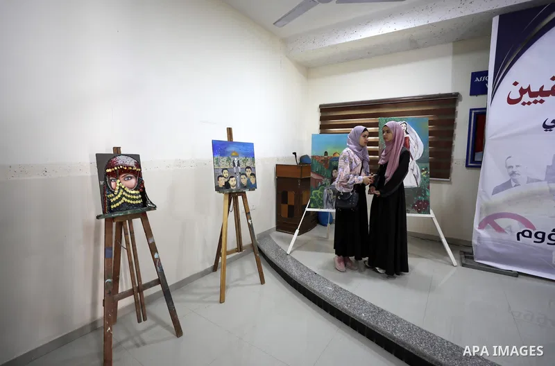 Palestinians attend the "Our Land" art exhibition on the 104th anniversary of Britain's Balfour Declaration, in Gaza city, November 4, 2021. The Balfour Declaration was a public statement issued by the British government...