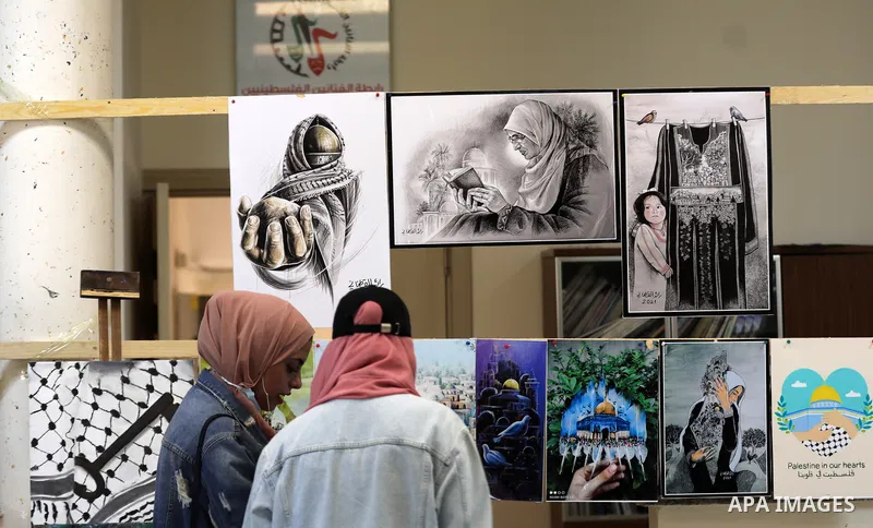 Palestinians attend the "Our Land" art exhibition on the 104th anniversary of Britain's Balfour Declaration, in Gaza city, November 4, 2021. The Balfour Declaration was a public statement issued by the British government...