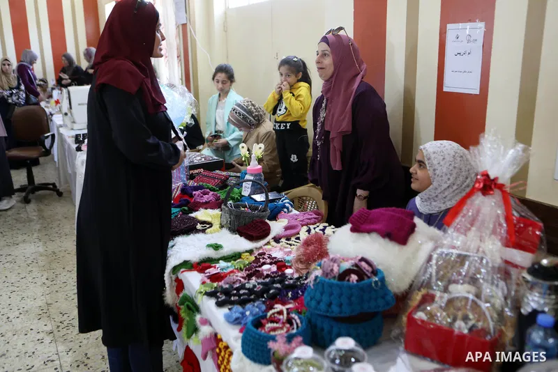Palestinian women take part in an exhibition of handicrafts in the village of Surif, north of the West Bank city of Hebron, on 06 November 2021. Photo by Mamoun Wazwaz