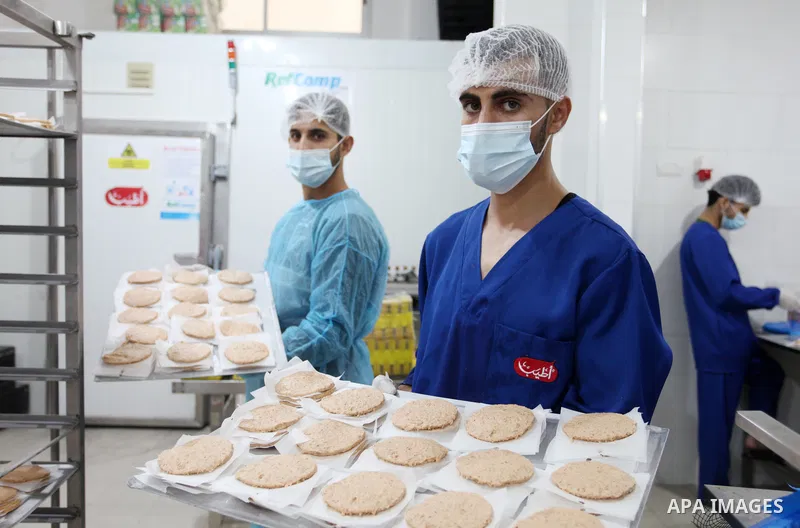 Palestinian workers prepare the chicken burger at atyab factory in Gaza City on 07 November. The first factory to manufacture chicken burgers in the Gaza Strip to meet the local market. Chicken burger is a proud supporte...