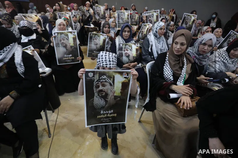 Palestinians take part in a ceremony to mark the 17th anniversary of death of late president Yasser Arafat, in Gaza city on November 11, 2021. Photo by Ashraf Amra