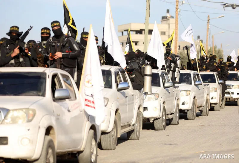Palestinian militants from the Al-Quds Brigades, the armed wing of the Islamic Jihad movement, take part in a military parade to mark the seconed anniversary of killed of Islamic Jihad commander, Bahaa Abu el-Atta, in Ga...