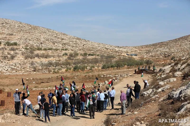 Palestinian protesters clash with Israeli security forces, during a demonstration against the establishment of Israeli outposts on Palestinian lands, in Beit Dajan, east of Nablus in the West Bank, on November 12, 2021....