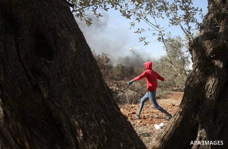 Palestinian protesters clash with Israeli forces during a demonstration against settlements in the village of Beita in the West Bank, on November 12, 2021. Photo by Shadi Jarar'ah