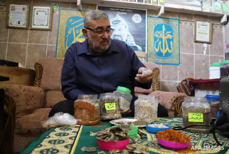 A Palestinian specialist in alternative medicine, Jamal Inaya, 60, displays the natural herbs at a small clinic in his home in Khan Yunis in the southern Gaza Strip, on November 14, 2021. Traditional Palestinian Medicine...