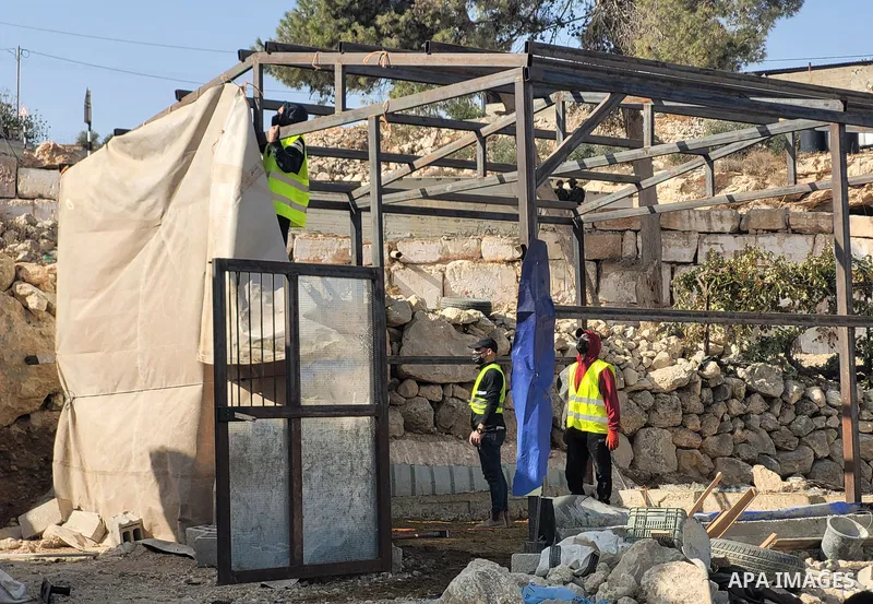 Israeli security forces confiscate barracks in the Palestinians residential area after Israeli authorities said it was built without a permit in Yatta south of Hebron in the occupied West Bank, on November 15, 2021. Acco...