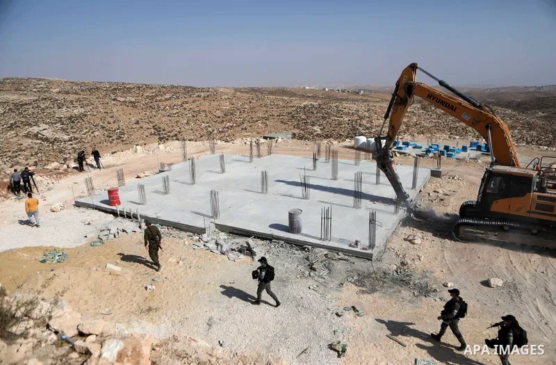 An Israeli bulldozer demolished a Palestinian house located under the pretext of building without a permit in Yatta south of Hebron in the occupied West Bank, on November 15, 2021. According to a report by the Israeli hu...