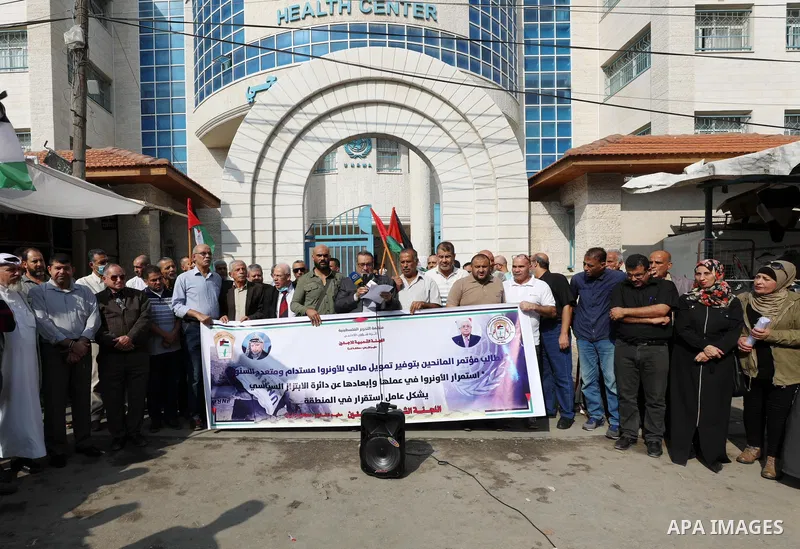 Palestinians take part in a protest in front of a United Nations-run health center, in Gaza city on November 17, 2021. Hundreds of refugees participated today in a protest to demand sustainable funding for the agency and...