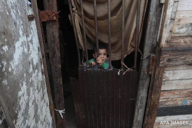 Palestinians show as they in their daily lives during a rainy day, in Deir al-Balah in the center of Gaza strip on November 21, 2021. The effects of the low pressure front which affected Palestine yesterday are expected...
