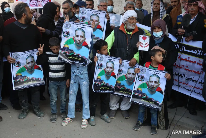 Palestinians take part in a protest against the death of prisoner Sami al-Amour in Israeli Jails as a result of intentional medical negligence, in Red cross office, in Gaza city on November 22, 2021. The al-Amour, 39, fr...