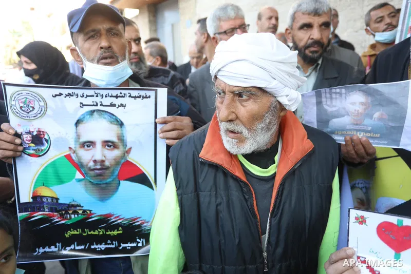 Palestinians take part in a protest against the death of prisoner Sami al-Amour in Israeli Jails as a result of intentional medical negligence, in Red cross office, in Gaza city on November 22, 2021. The al-Amour, 39, fr...