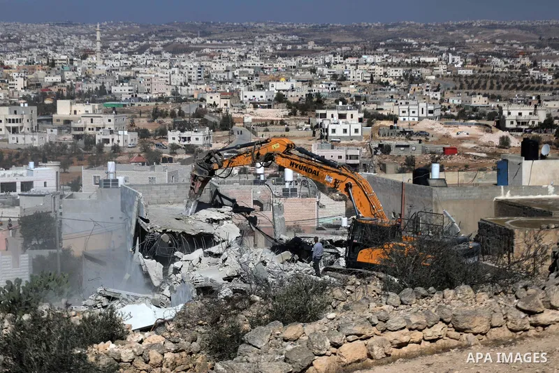 An Israeli bulldozer demolished a Palestinian house located under the pretext of building without a permit in Yatta south of Hebron in the occupied West Bank, on November 23, 2021. According to a report by the Israeli hu...