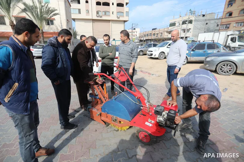 Palestinian engineers invent a street sweeping machine, in Deir al-Balah, in the center of Gaza strip, on November 25, 2021. Engineers invented a machine for sweeping and cleaning streets to facilitate the work of cleane...