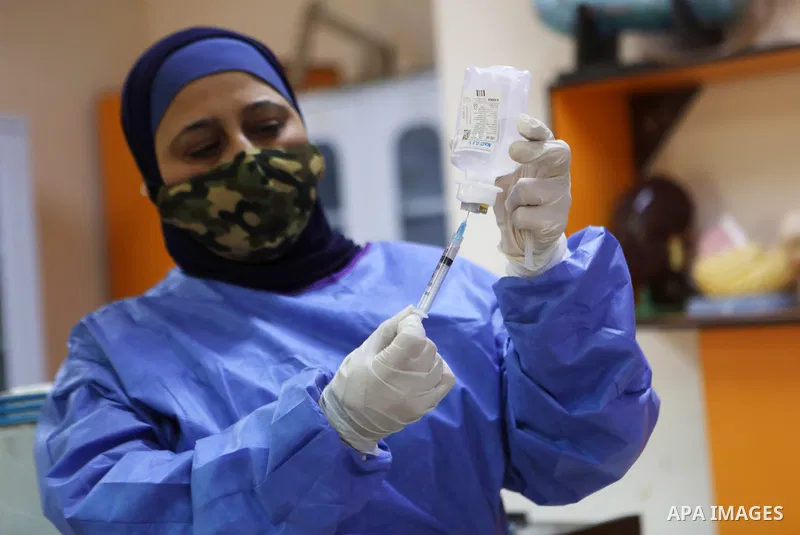 Palestinian students receive the first dose of COVID-19 vaccine during a vaccination campaign, at a school in the West Bank of Hebron on Nobember 25, 2021. Photo by Mamoun Wazwaz