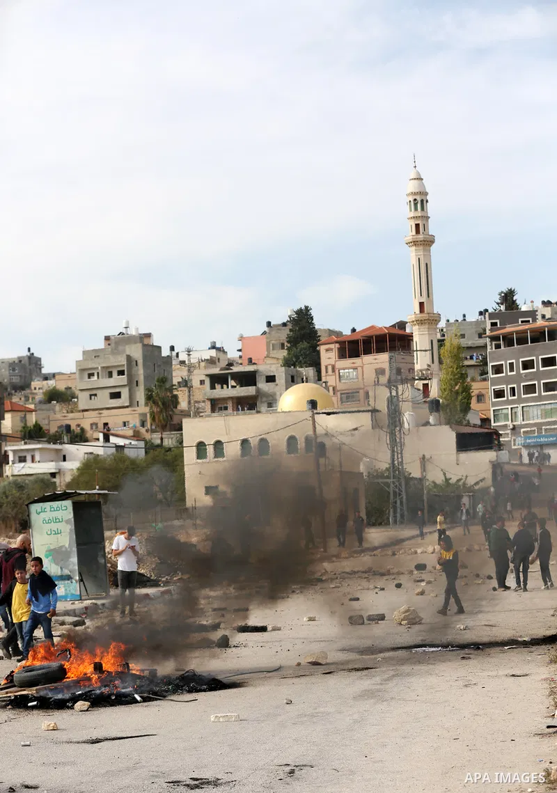 Israeli forces and Palestinian demonstrators clash in the village of al-Lubban al-Sharqiya in the Israeli-occupied West Bank on November 25, 2021. Photo by Ayman Ameen