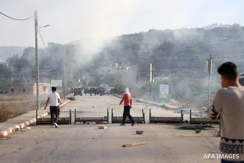 Israeli forces and Palestinian demonstrators clash in the village of al-Lubban al-Sharqiya in the Israeli-occupied West Bank on November 25, 2021. Photo by Wajed Nobani
