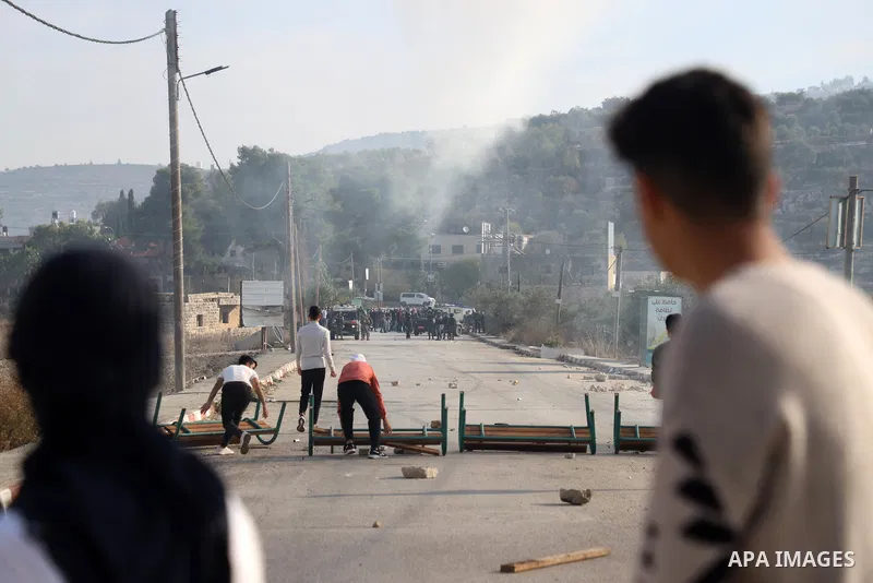 Israeli forces and Palestinian demonstrators clash in the village of al-Lubban al-Sharqiya in the Israeli-occupied West Bank on November 25, 2021. Photo by Wajed Nobani