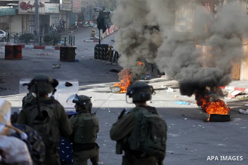 Palestinian protesters and Israeli security forces clash in the West Bank city of Hebron on November 26, 2021. Photo by Mamoun Wazwaz