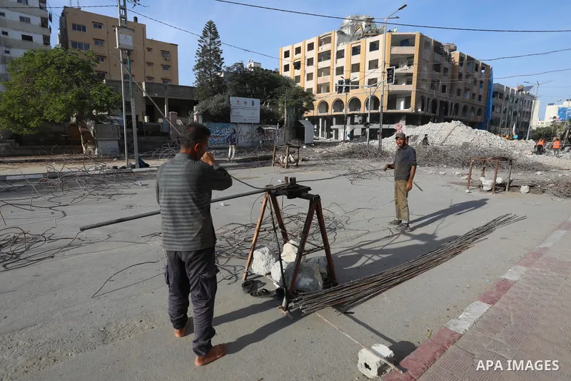 Palestinian workers remove the rubbles of al-Jawhara tower which was hit by Israeli strikes during the recent 11-day conflict between Israel and Hamas on May, in Gaza city on November 25, 2021. People and businesses in t...